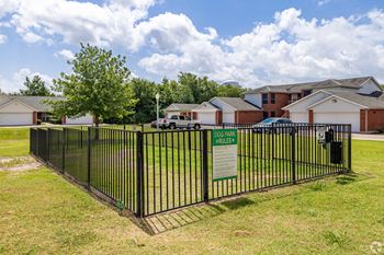 a wrought iron fence with a sign in front of some houses